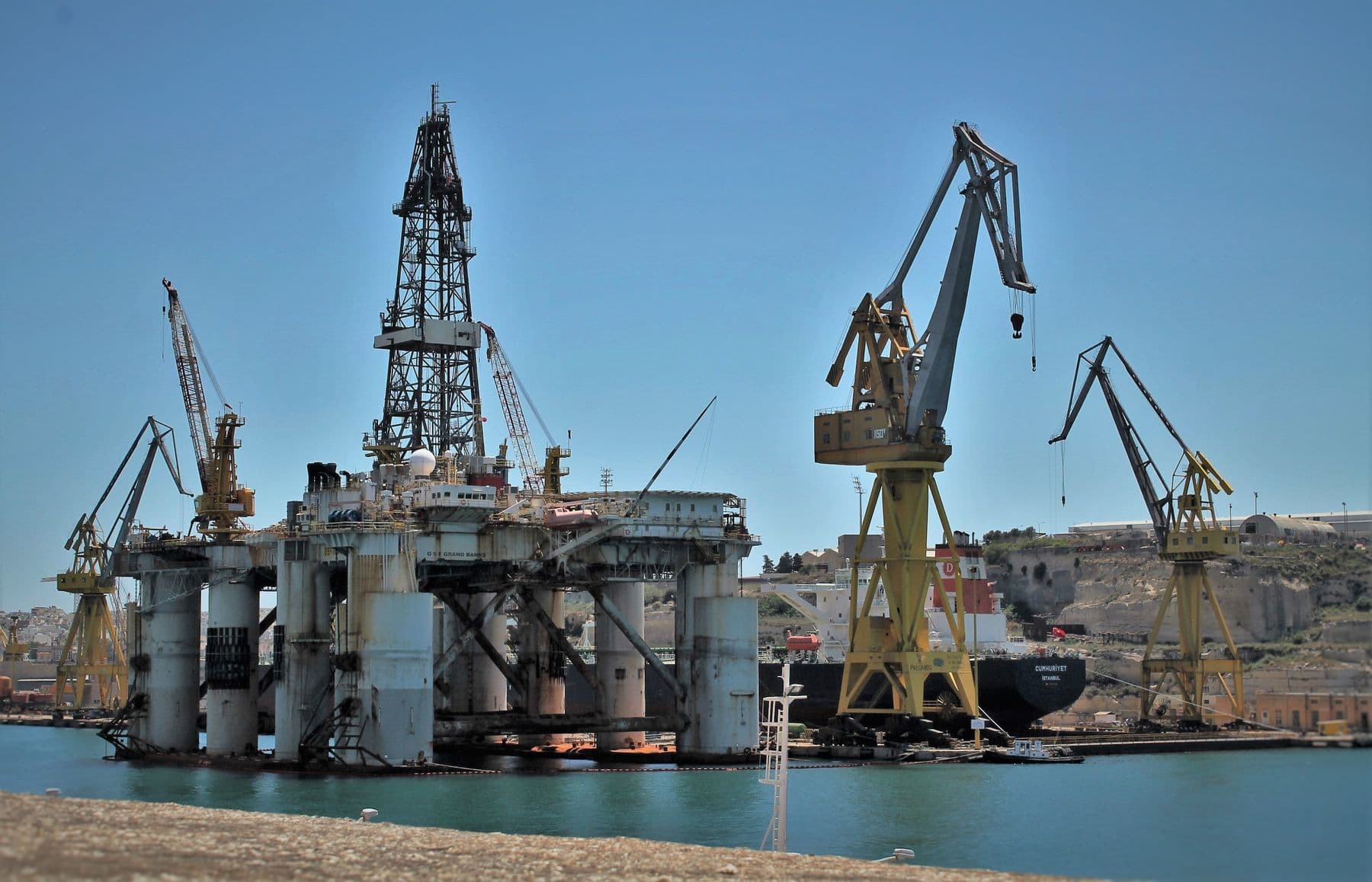 Row of shipyard cranes over a construction dock