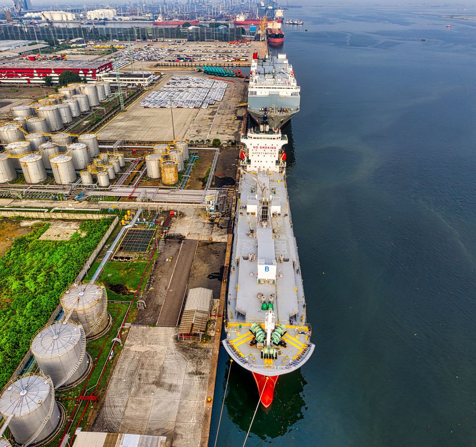 Aerial view of a tanker berthed alongside a coastal storage terminal